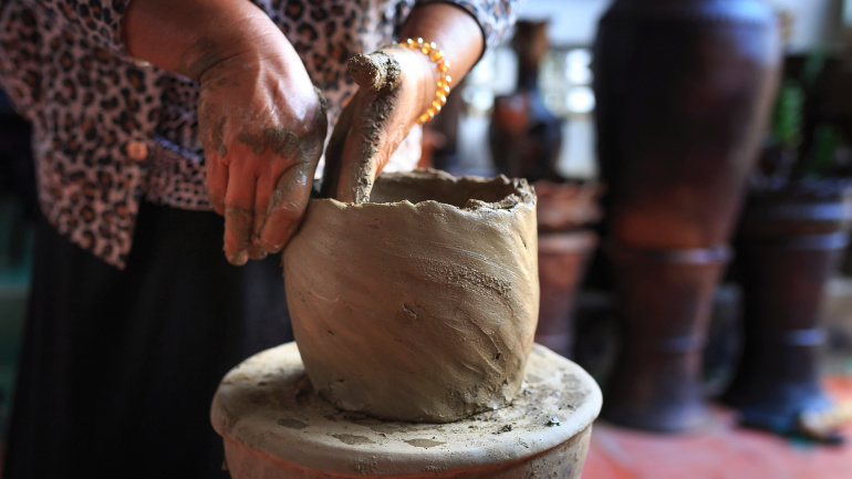 potter using wheel in ceramics course