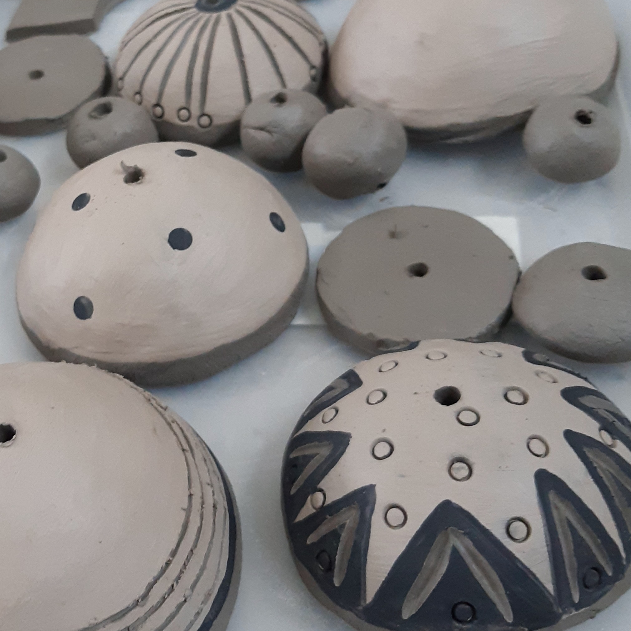 a selection of clay shapes created on a pottery course with different patterns and textures