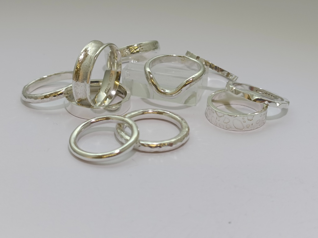 a selection of silver rings made in a jewellery course