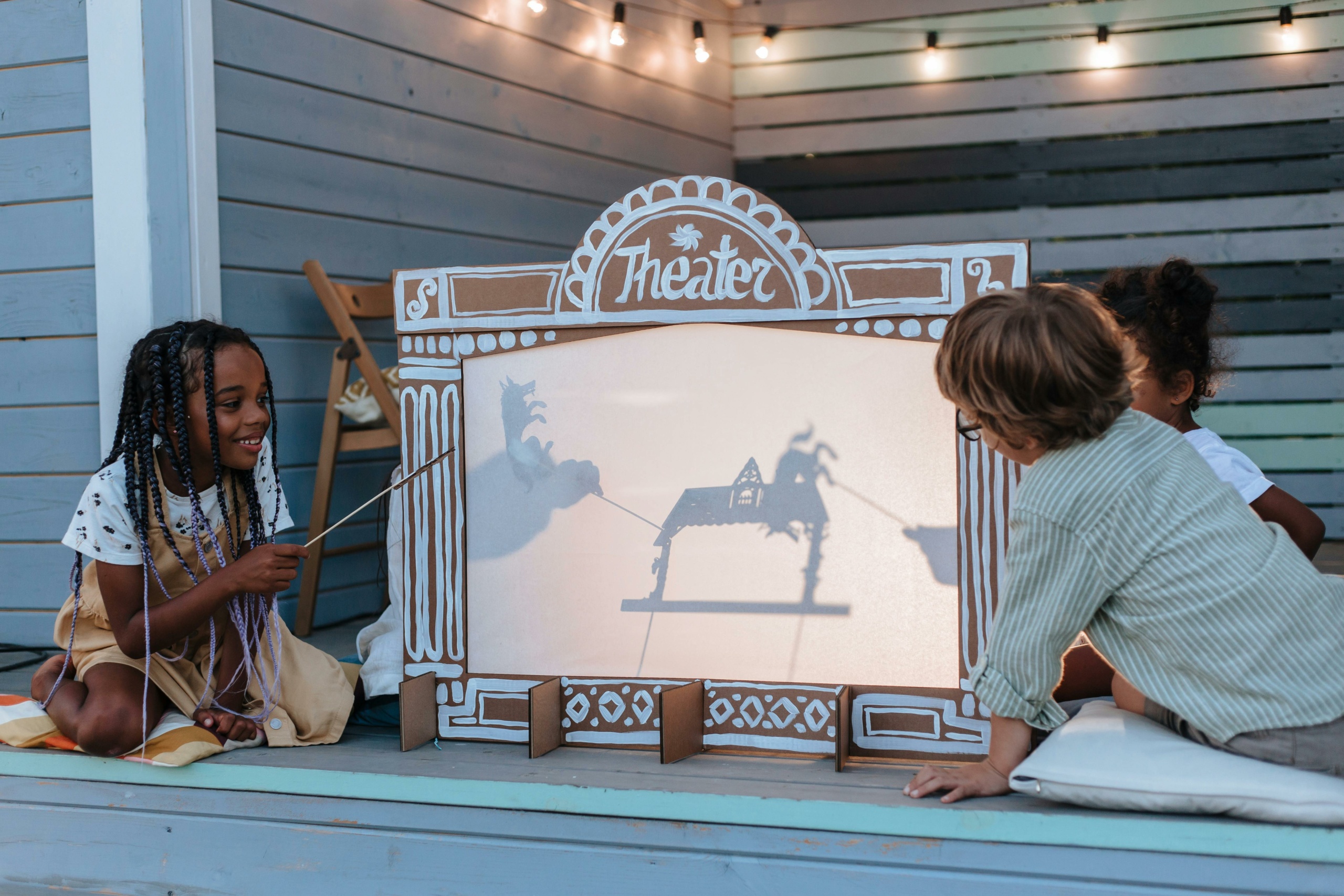 children playing with a shadow puppet theatre